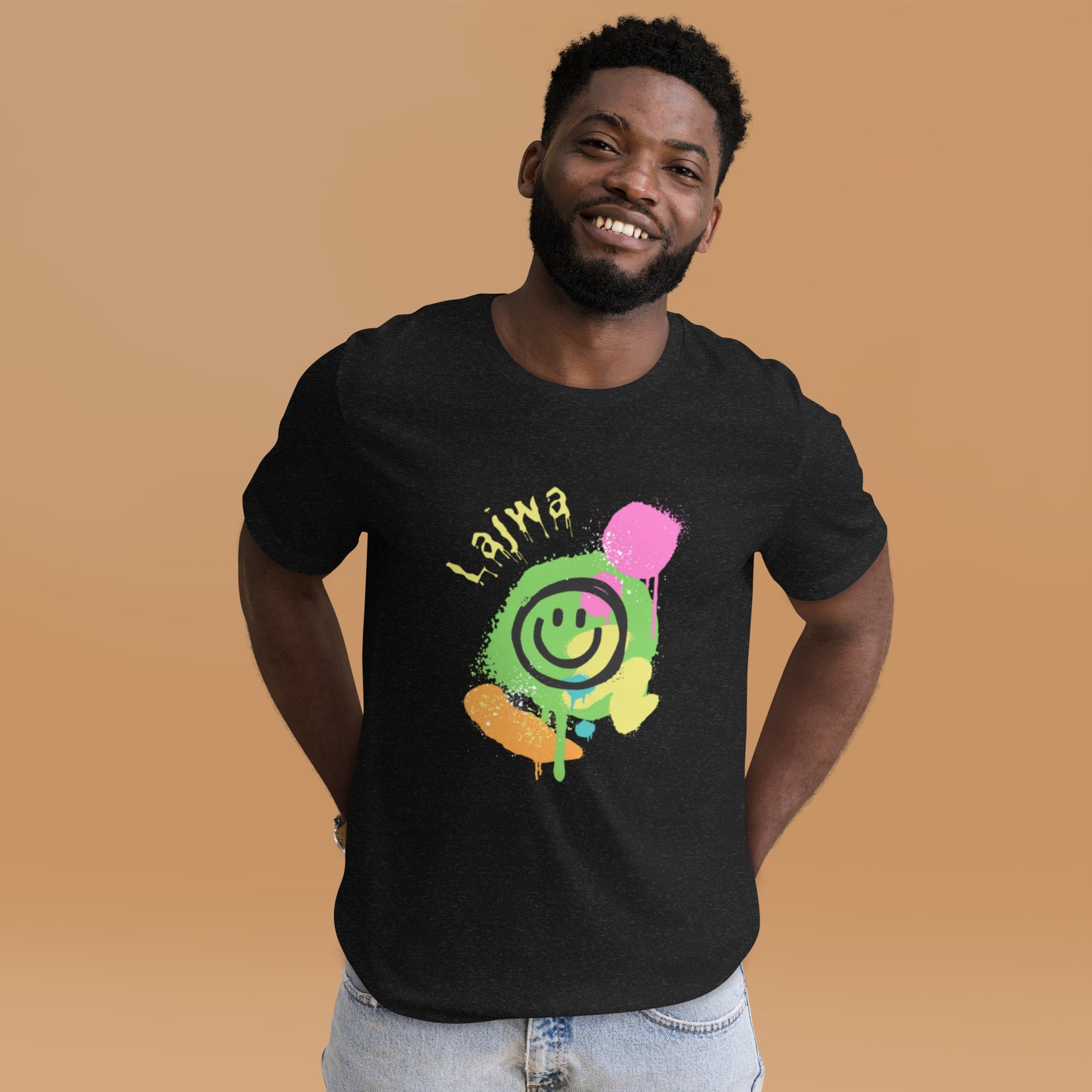 Smiling black male model wearing a black Bella+Canvas 'Lajwa' unisex T-shirt (front view) with a colorful dripping paint smiley face graphic in bright pink, green, orange, and yellow.