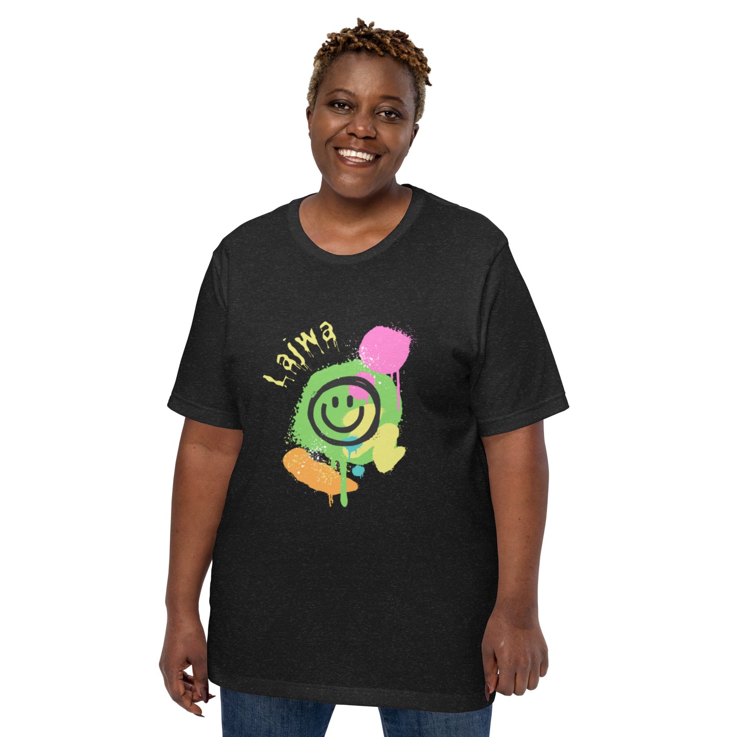 Smiling black female model wearing a black XL Bella+Canvas 'Lajwa' unisex T-shirt (front view) with a colorful dripping paint smiley face graphic in bright pink, green, orange, and yellow.