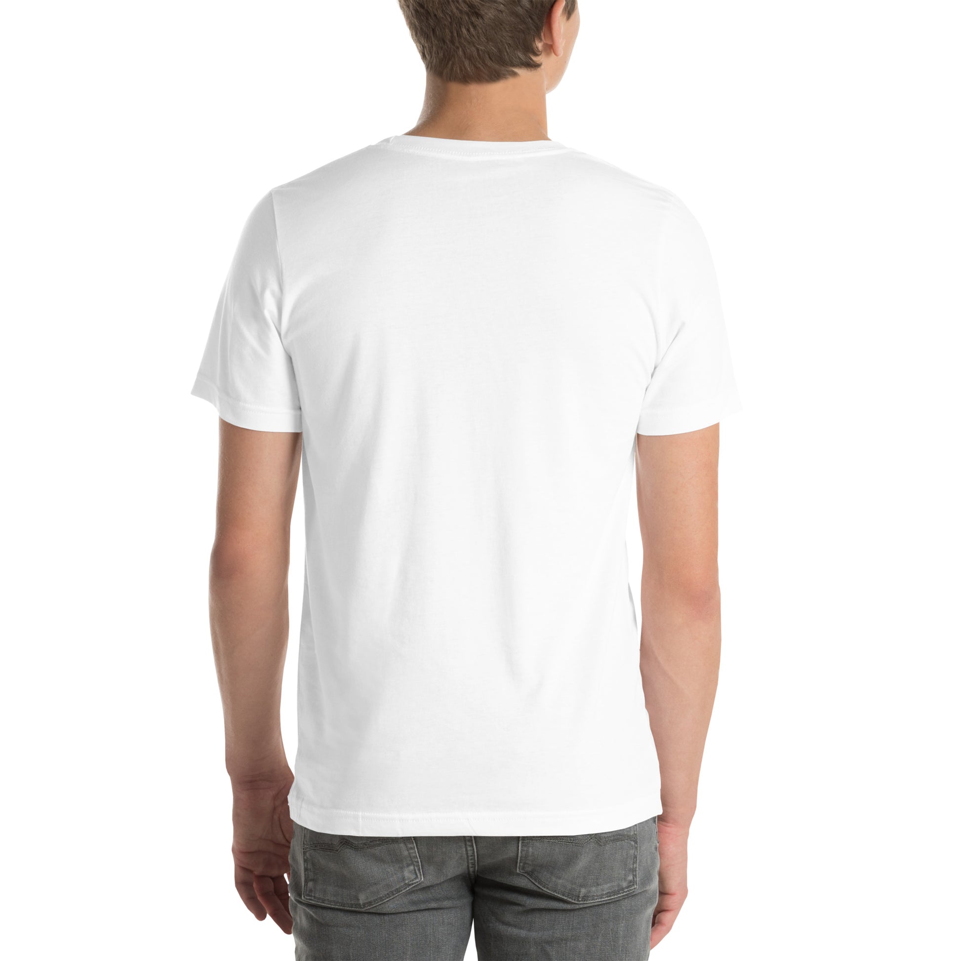 White man wearing a white Bella+Canvas 'Nan Lanmou Nou Kwe' unisex T-shirt (back view) featuring a pink and blue abstract heart graphic with a smiley face and paint drip accents.