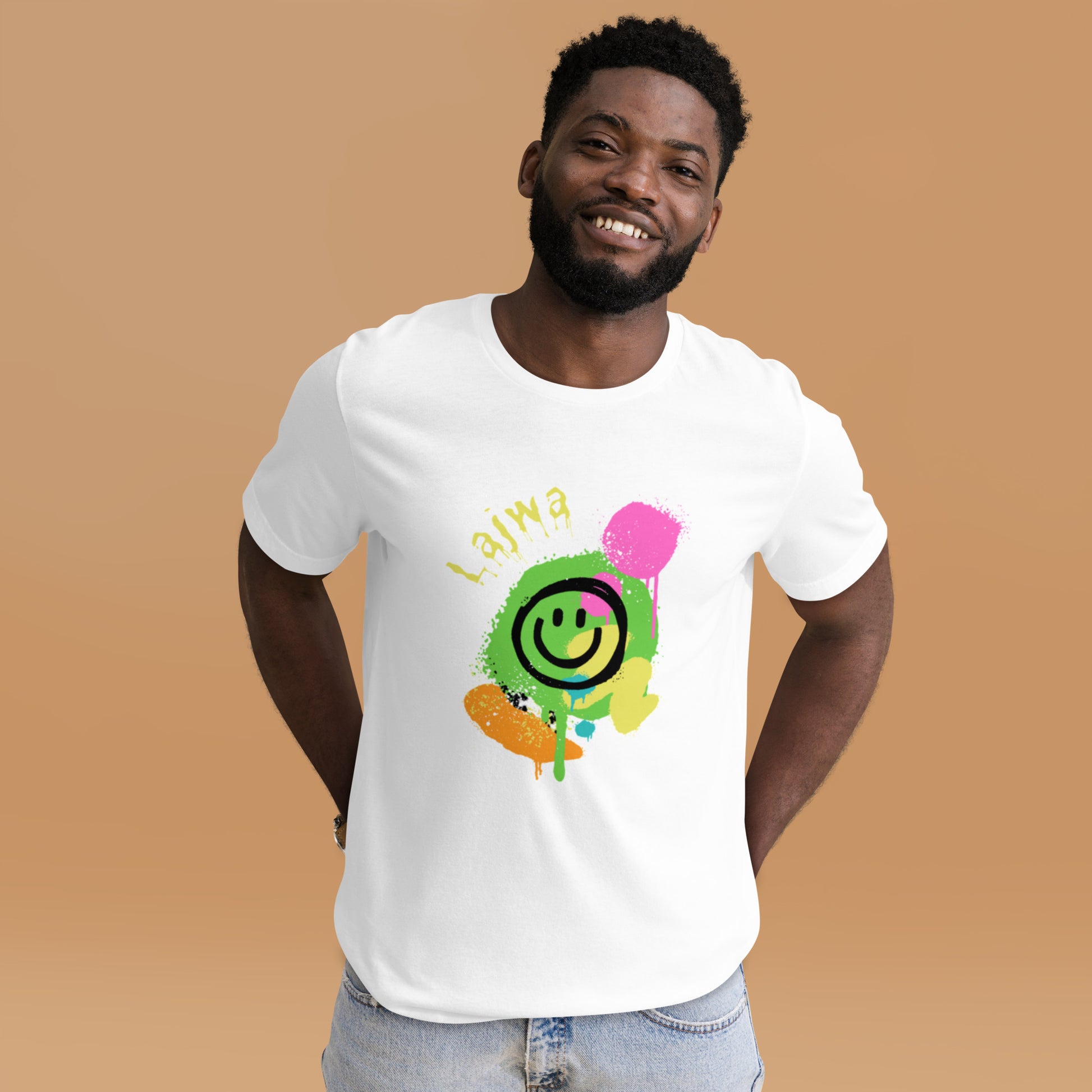 Black male model smiling in a white Bella+Canvas 'Lajwa' unisex T-shirt (front view) with a colorful dripping paint smiley face graphic in bright pink, green, orange, and yellow.