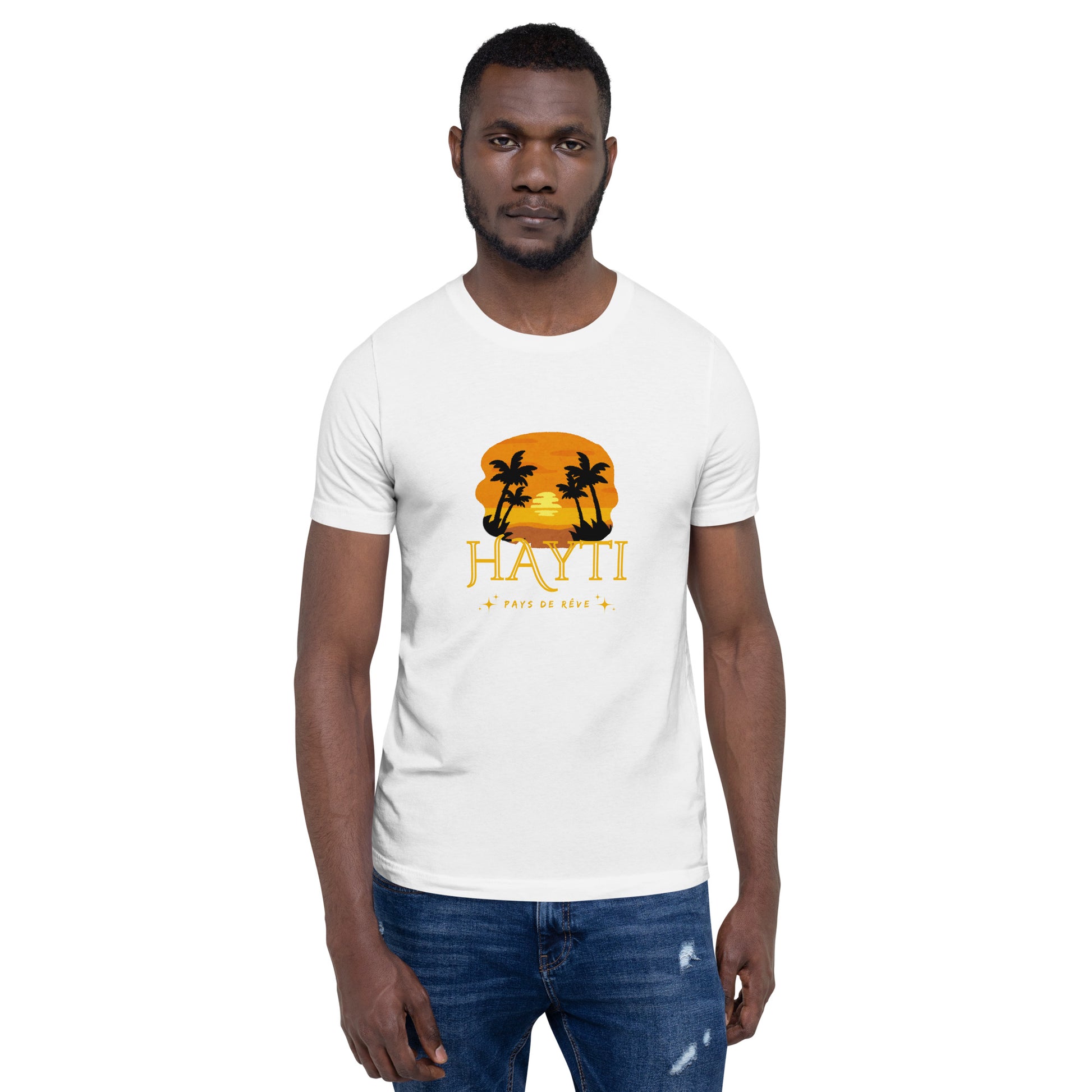 Black man wearing a white Bella+Canvas 'HAYTI PAYS DE RÊVE' unisex T-shirt (front view) featuring a golden hour sunset graphic with palm trees and twinkling stars. White background.