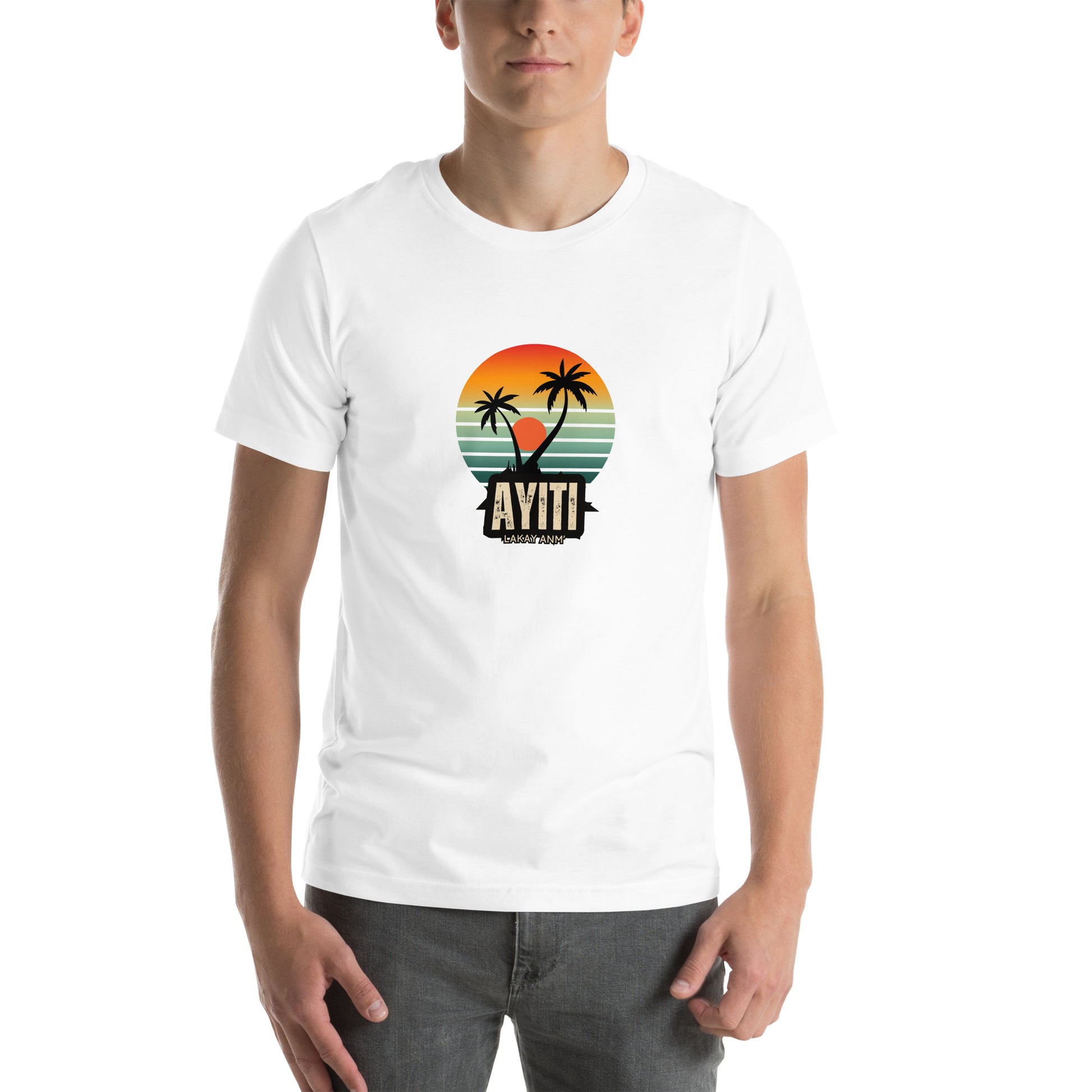 White male model wearing a white Bella+Canvas 'Ayiti Lakay Anm'' unisex T-shirt (front view) featuring a vibrant retro sunset graphic with two palm trees silhouetted. White background.