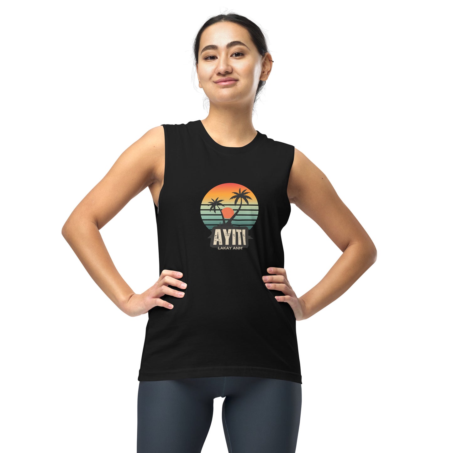 Female model wearing a Black Bella+Canvas 'AYITI LAKAY ANM'' unisex muscle tank top (front view) with a vibrant orange and blue sunset graphic featuring two palm trees silhouetted.