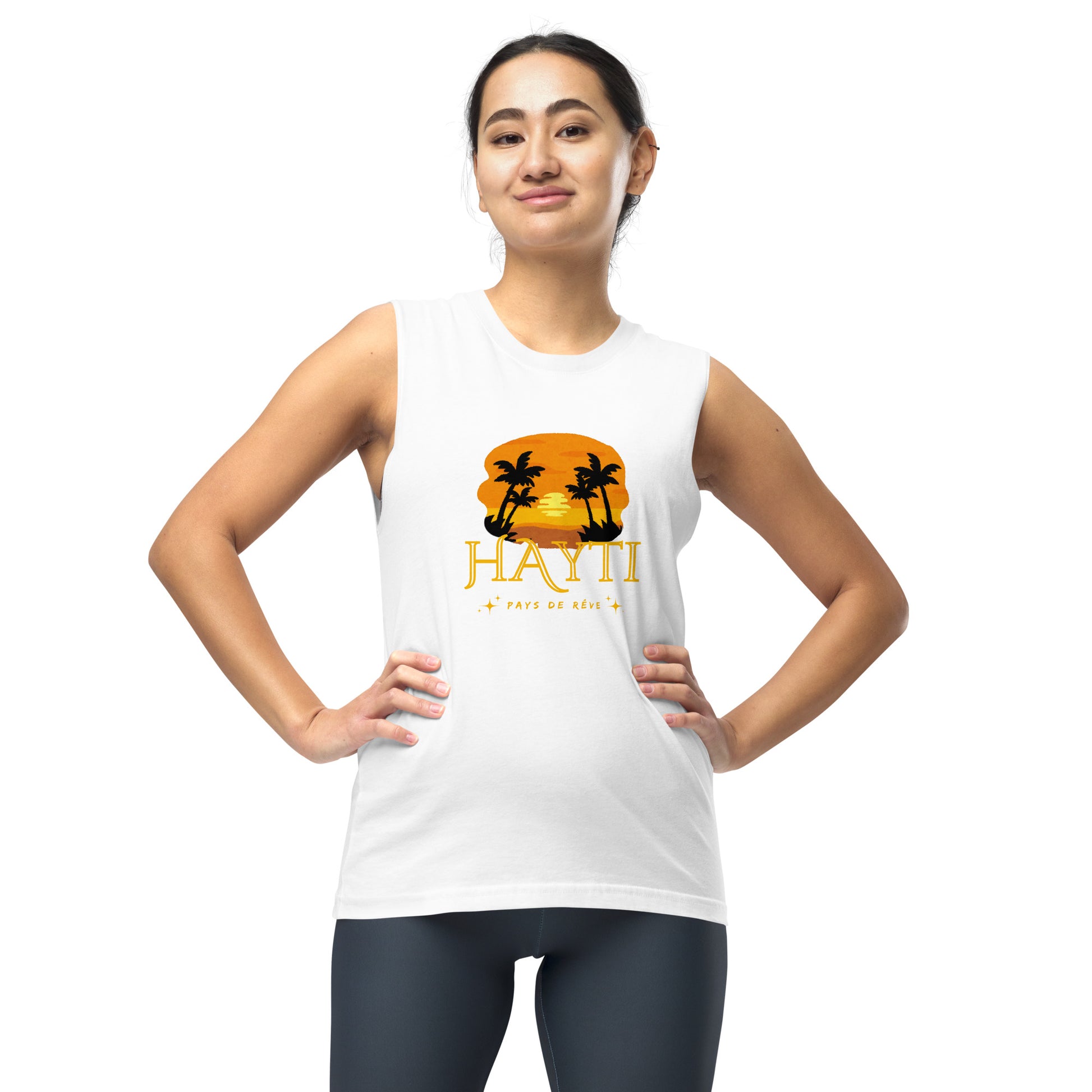 Female model wearing a white Bella+Canvas 'HAYTI PAYS DE RÊVE' unisex muscle tank top (front view) featuring a golden hour sunset graphic with palm trees and twinkling stars. White background.