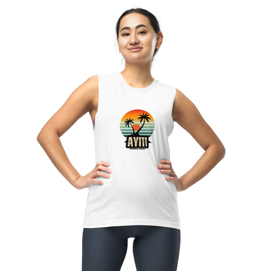 Female model wearing a white Bella+Canvas 'AYITI LAKAY ANM'' unisex muscle tank top (front view) with a vibrant orange and blue sunset graphic featuring two palm trees silhouetted. White background.