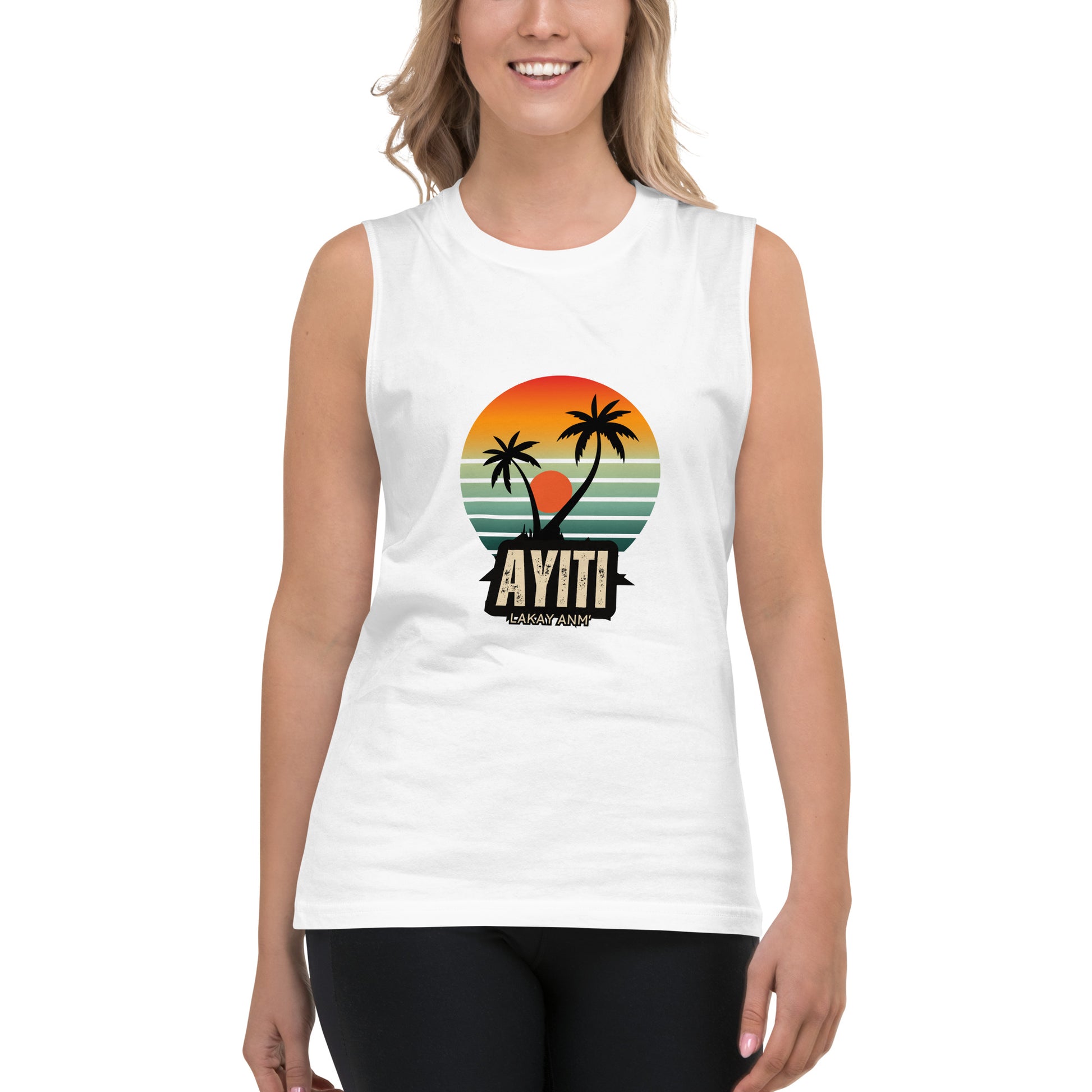 Female model wearing a white Bella+Canvas 'AYITI LAKAY ANM'' unisex muscle tank top (front view) with a vibrant orange and blue sunset graphic featuring two palm trees silhouetted. White background.