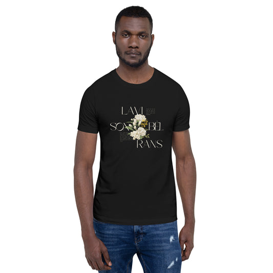 Man wearing a black Bella+Canvas 'LAVI S'ON BÈL RANS' unisex T-shirt (front view) featuring cream text and a realistic white floral graphic. The man has short dark hair and is wearing blue jeans.