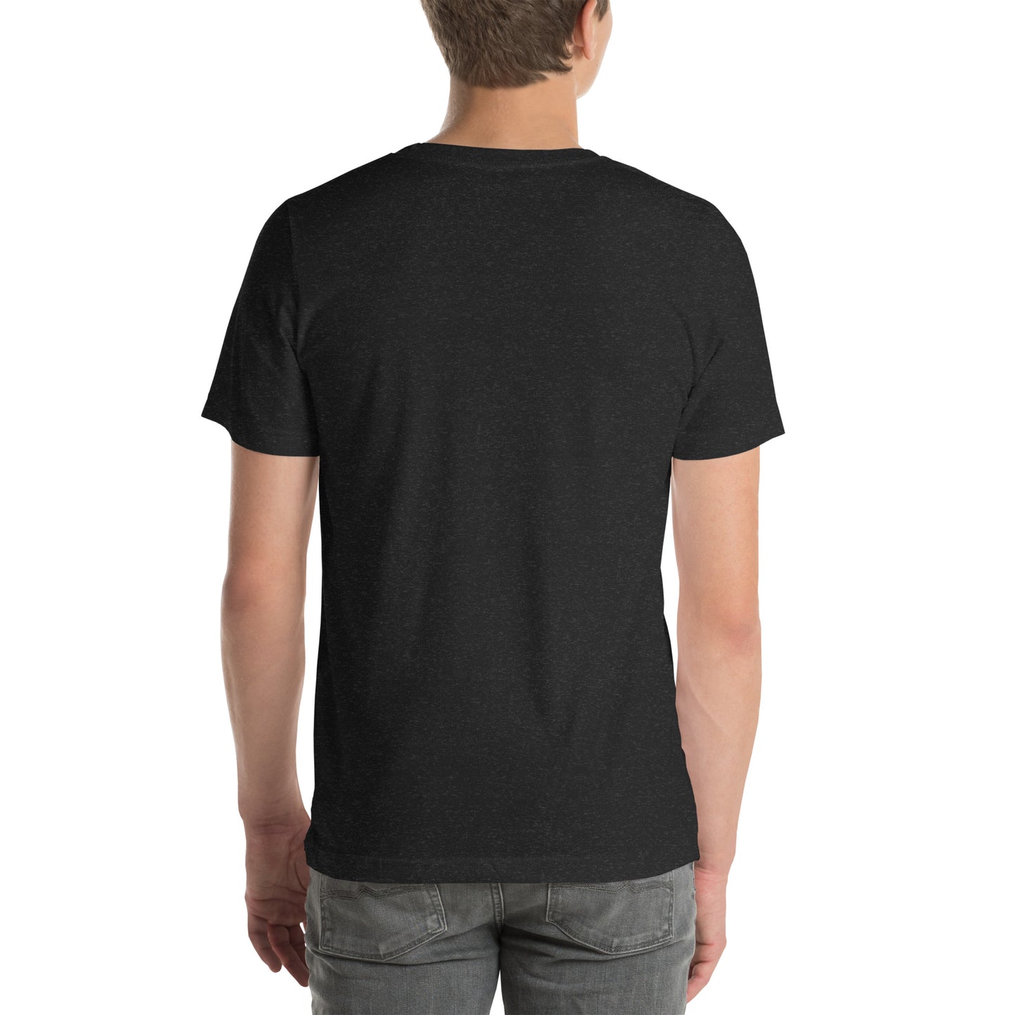 White man wearing a black Bella+Canvas 'Nan Lanmou Nou Kwe' unisex T-shirt (back view) featuring a pink and blue abstract heart graphic with a smiley face and paint drip accents.