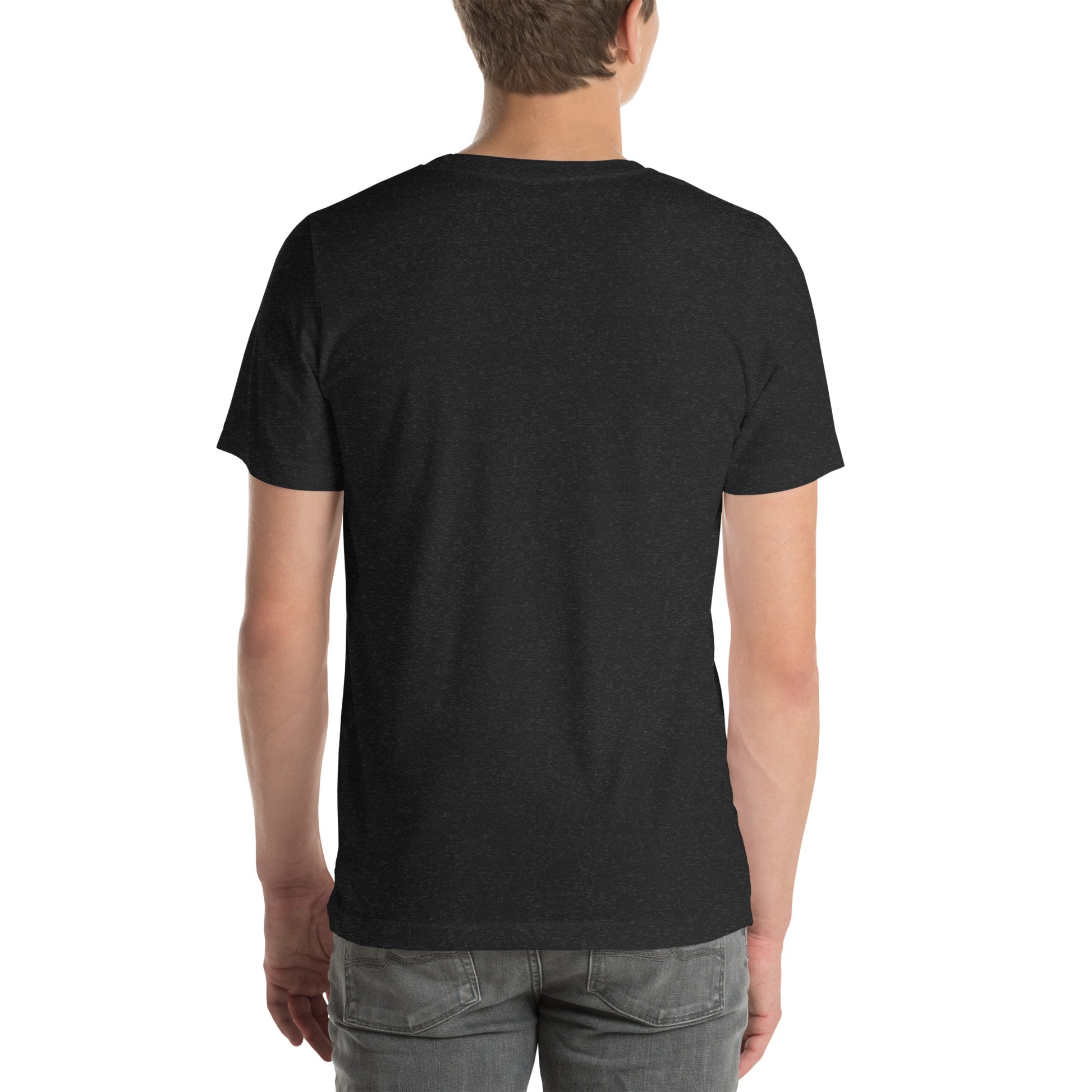 White man wearing a black Bella+Canvas 'Nan Lanmou Nou Kwe' unisex T-shirt (back view) featuring a pink and blue abstract heart graphic with a smiley face and paint drip accents.