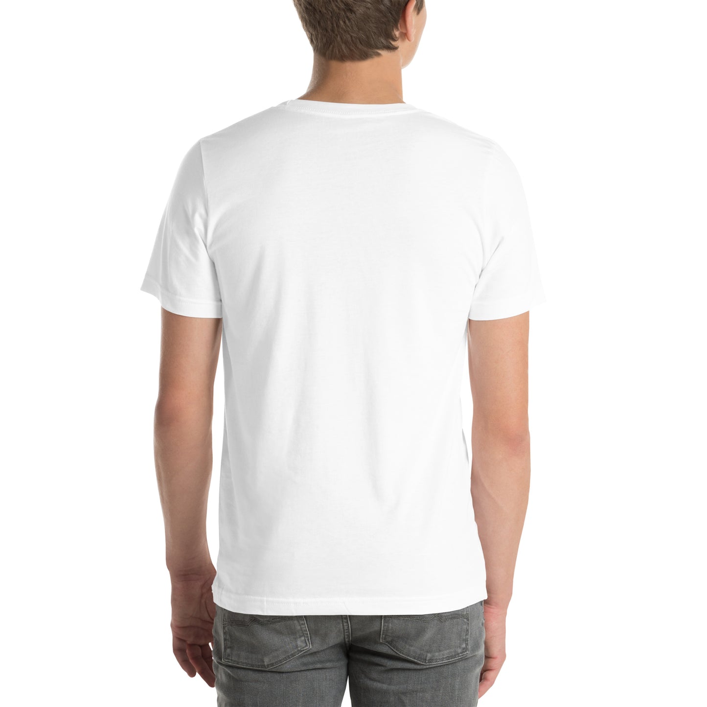White man wearing a white Bella+Canvas 'Nan Lanmou Nou Kwe' unisex T-shirt (back view) featuring a pink and blue abstract heart graphic with a smiley face and paint drip accents.
